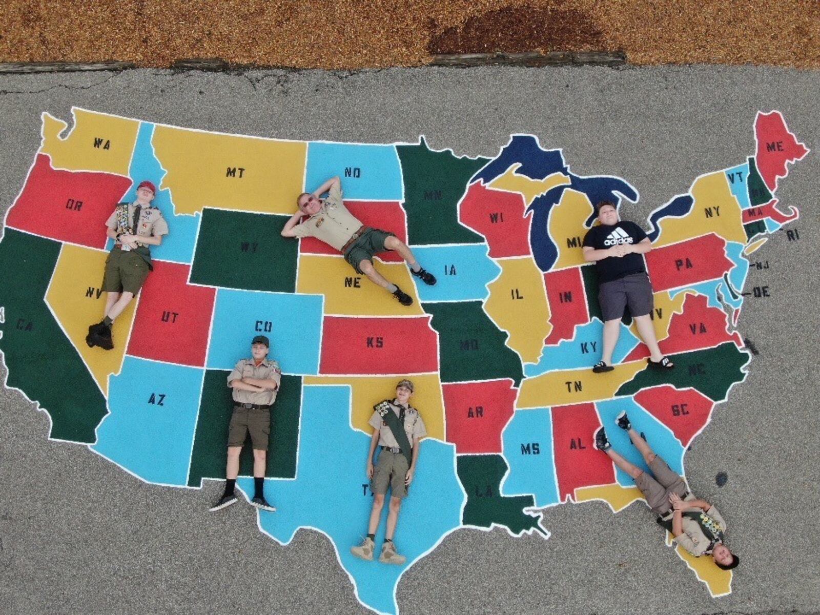 Vincent Ariss, now a senior at Butler Tech, wanted to reach back and help younger students at his old school - Fairfield North Elementary - with a subject that frustrated him as a grade schooler - American geography. Specifically, Ariss (far left, pictured in an aerial drone photo) wanted to help students learn the states so he and others painted a giant map of America on the playground of his former school. (Provided Photo\Journal-News)