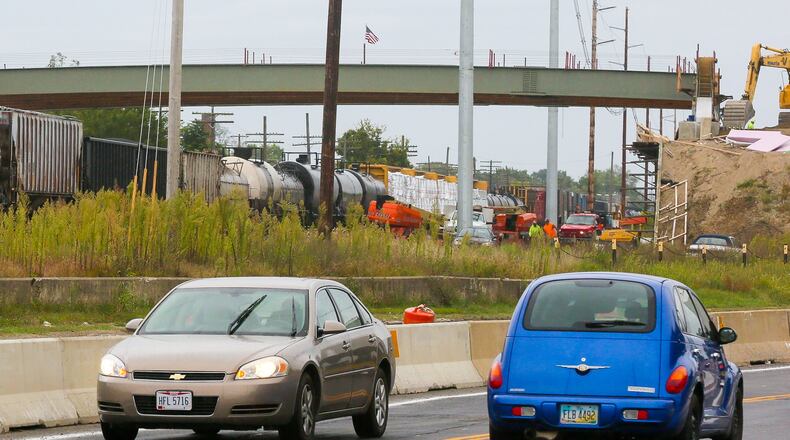 Construction continues at the South Hamilton Crossing, Tuesday, Sept. 12, 2017. A steel beam has been placed on the train overpass and traffic is now flowing in both directions on the relocated Pleasant Ave. GREG LYNCH / STAFF