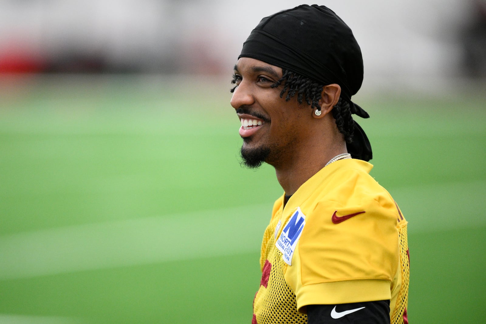 Washington Commanders quarterback Jayden Daniels looks on during an NFL football practice, Wednesday, May 28, 2025, in Ashburn, Va. (AP Photo/Nick Wass)