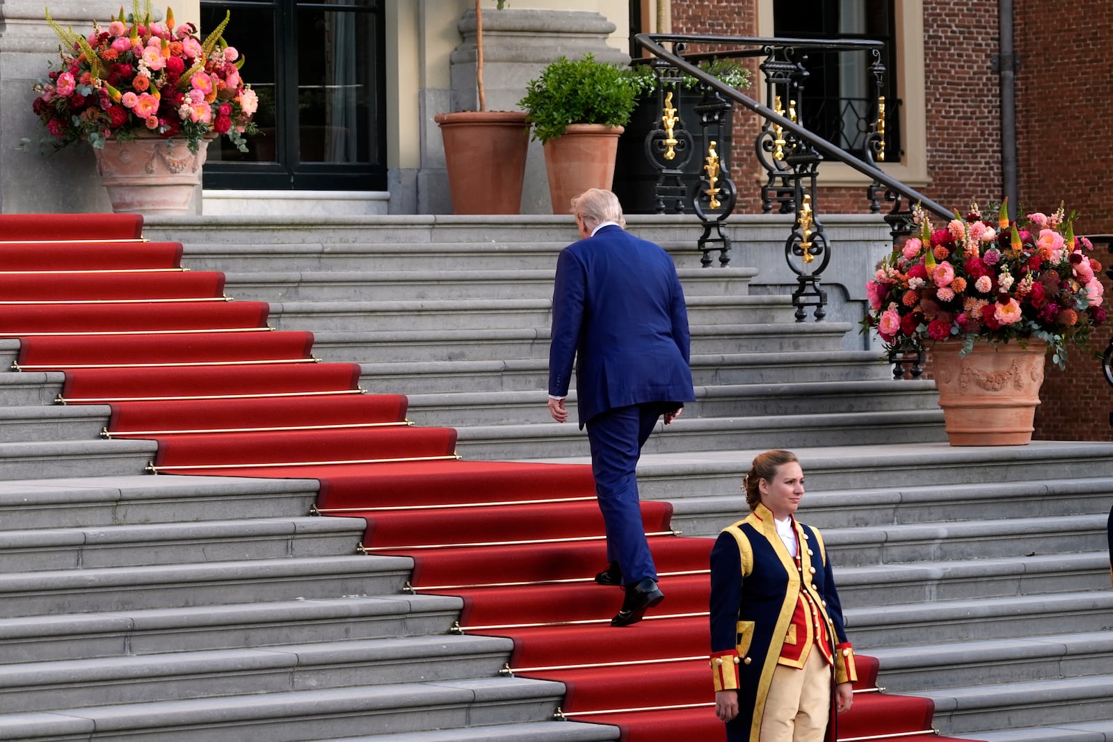 President Donald Trump climbs the stairs to the Paleis Huis ten Bosch ahead of the NATO summit in The Hague, Netherlands, Tuesday, June 24, 2025. (AP Photo/Alex Brandon)