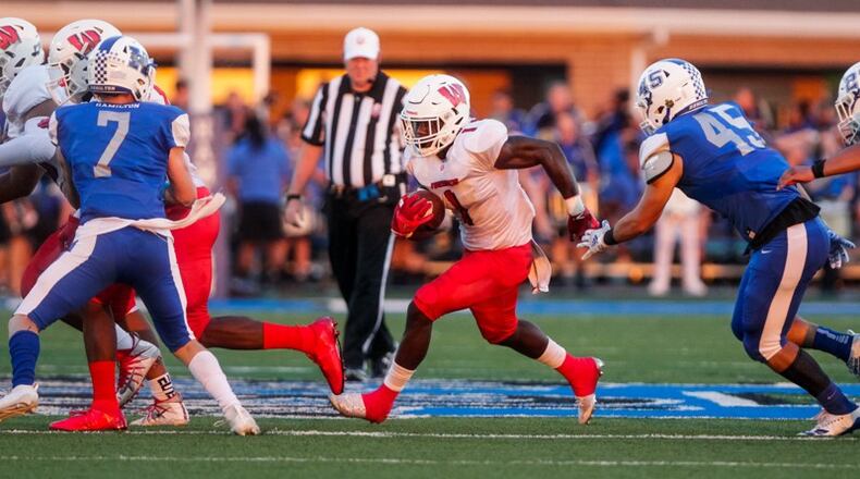 Lakota West’s David Afari runs the ball vs. Hamilton during Friday night’s game at Virgil Schwarm Stadium. Nick Graham/STAFF