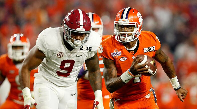 GLENDALE, AZ - JANUARY 11: Deshaun Watson #4 of the Clemson Tigers runs the ball in the third quarter against Da'Shawn Hand #9 of the Alabama Crimson Tide during the 2016 College Football Playoff National Championship Game at University of Phoenix Stadium on January 11, 2016 in Glendale, Arizona. (Photo by Christian Petersen/Getty Images)