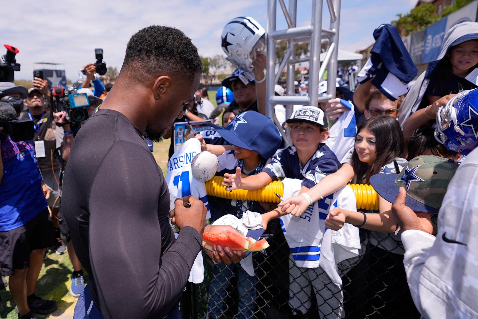 Dallas Cowboys defensive end Micah Parsons signs autographs during training camp Tuesday, July 22, 2025, in Oxnard, Calif. (AP Photo/Mark J. Terrill)