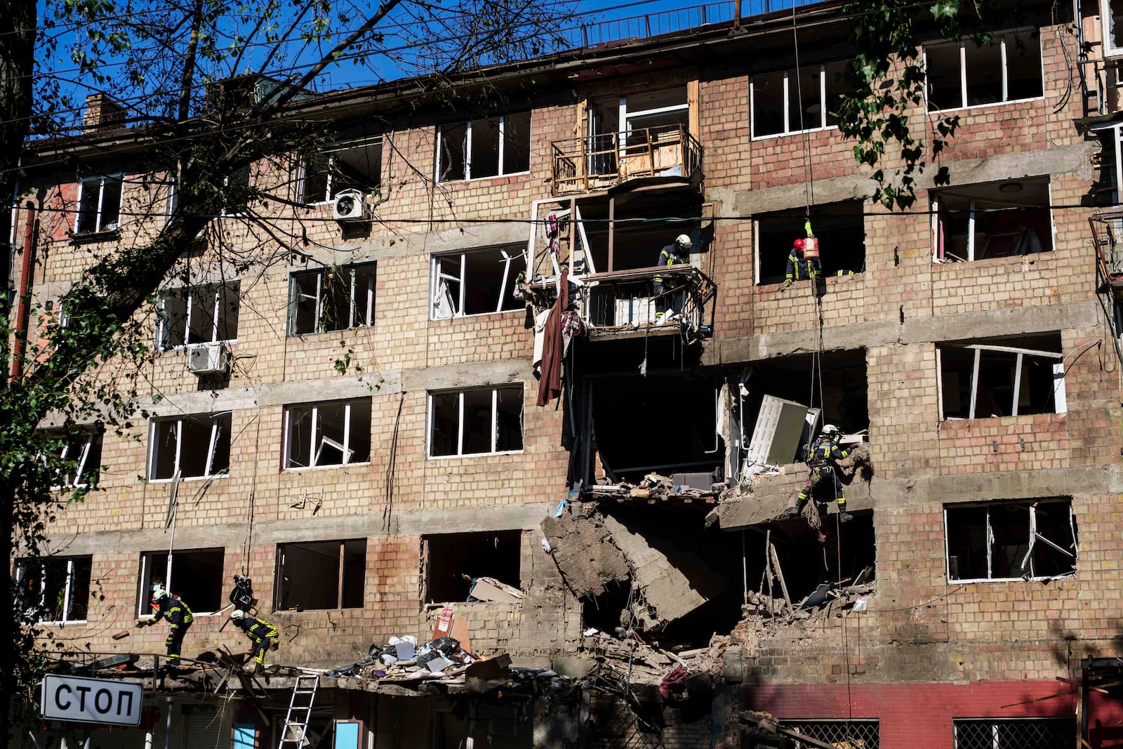 Rescue workers clear the rubble of a residential house damaged by a Russian strike in Kyiv, Ukraine, on Friday, July 4, 2025. (AP Photo/Evgeniy Maloletka)