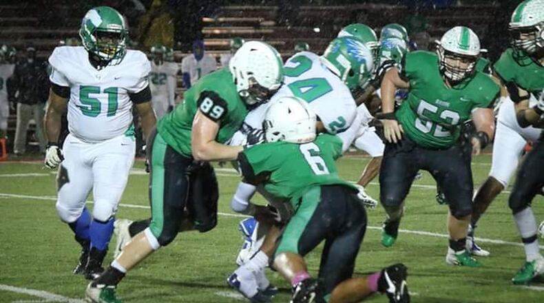 Badin’s Grayson Taylor (89) and Jayden Carter (6) bring down Chaminade Julienne running back Quincy Johnson (24) on Friday night at Fairfield Stadium in Fairfield. Badin took a 38-21 victory. CONTRIBUTED PHOTO BY TERRI ADAMS