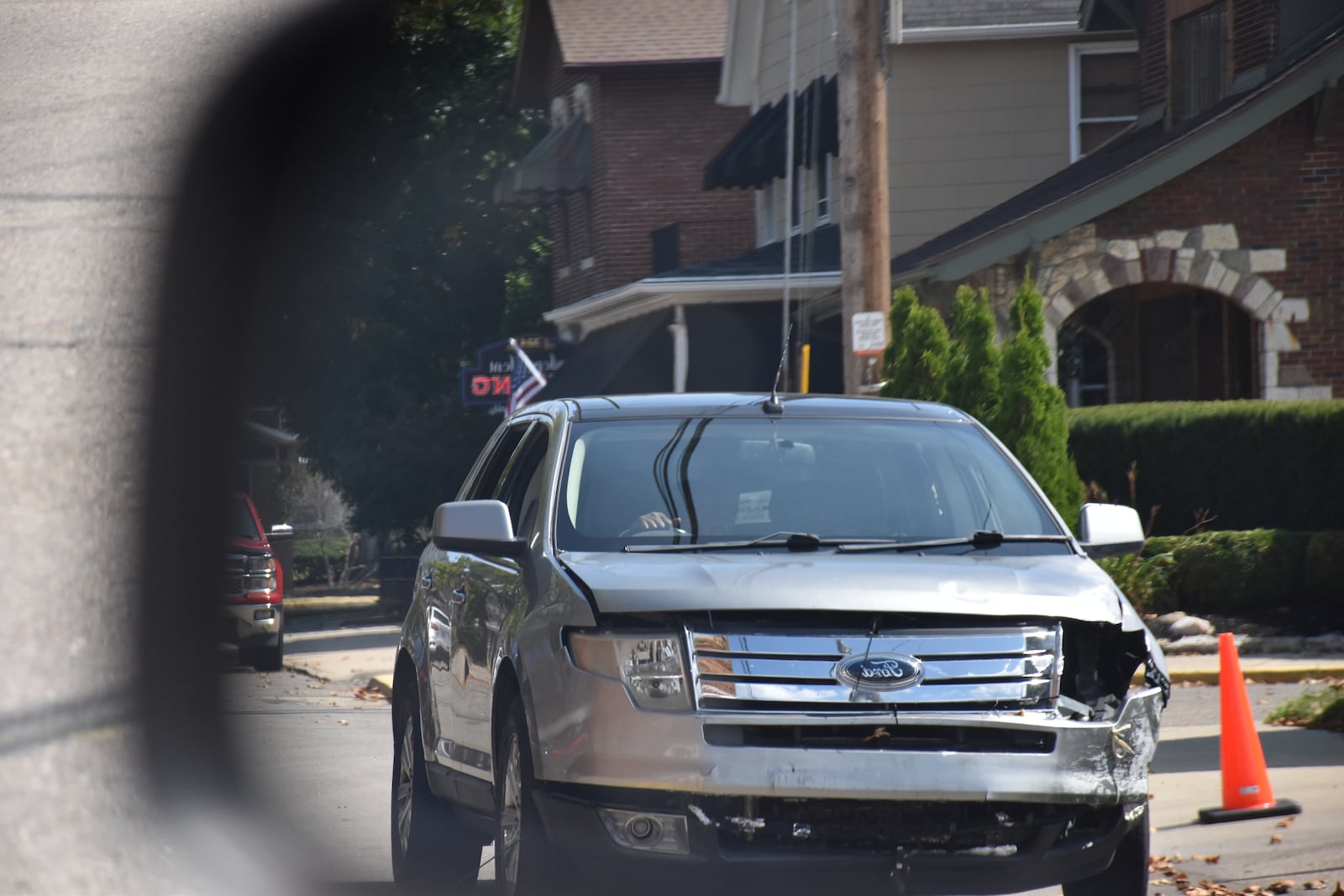 A Ford truck with front end damage drives on a Dayton area roadway. CORNELIUS FROLIK / STAFF