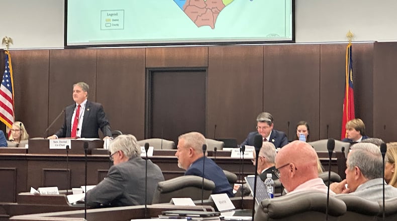 North Carolina state Sen. Warren Daniel, R-Burke (left and standing), presides over the Senate Committee on Elections while it considers legislation to redraw the state's U.S. House district map at the Legislative Office Building in Raleigh N.C., Monday, Oct. 20, 2025. (AP Photo/Gary D. Robertson)
