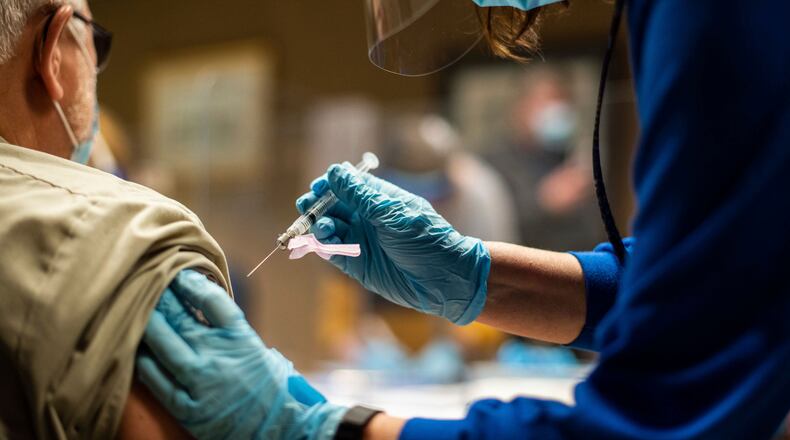 FILE- In this Feb. 2, 2021 file photo, Tyson Foods team members receive COVID-19 vaccines from health officials at the Wilkesboro, N.C. facility. Tyson Foods will require all of its U.S. employees to get vaccinated against COVID-19, becoming one of the first major employer of frontline workers to so amid a resurgence of the virus. Tyson, one of the world’s largest food companies, announced Tuesday, Aug. 3, that members of leadership team must be vaccinated by Sept. 24 and the rest of its office workers by Oct. 1. (Melissa Melvin/AP Images for Tyson Foods File)