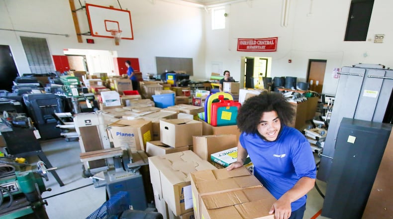 Crews from Planes Moving and Storage remove items from Fairfield Central Elementary on Tuesday, May 23. The building — Butler County’s second-oldest school — will be demolished in June.