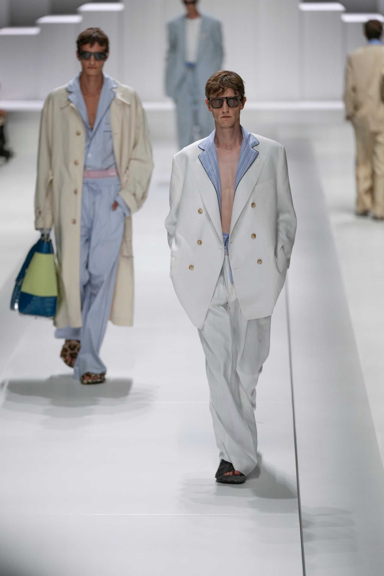 Models wear creations as part of the men's Dolce & Gabbana Spring-Summer 2026 collection, that was presented in Milan, Italy, Saturday, June 21, 2025. (AP Photo/Luca Bruno)