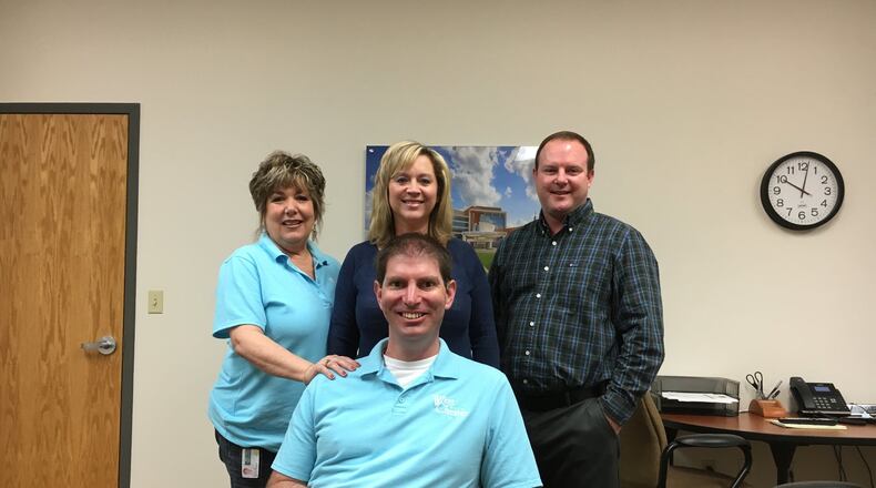 West Chester Twp. Planner Tim Dawson (right) is a valuable part of the Community Development Department so the trustees gave him a $10,000 to keep Warren County from stealing him away.