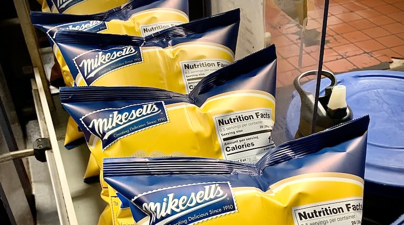 Bags of Mikesell's Potato chips on the conveyor belt Thursday Dec. 1, 2022. MARSHALL GORBY\STAFF