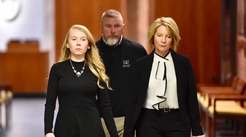 Brooke Skylar Richardson, left, arrives for a hearing today in Warren County Common Pleas Court with her parents Scott and Kimberly Richardson. The teen is charged with aggravated murder and other felonies for allegedly killing her infant and burying it in the back yard. NICK GRAHAM/STAFF