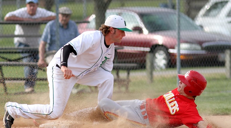 Badin third baseman Heath Stricker tags out Purcell Marian’s Vince Meinking to complete a double play after an out at home plate during a game at Alumni Field on April 30, 2012. JOURNAL-NEWS FILE PHOTO