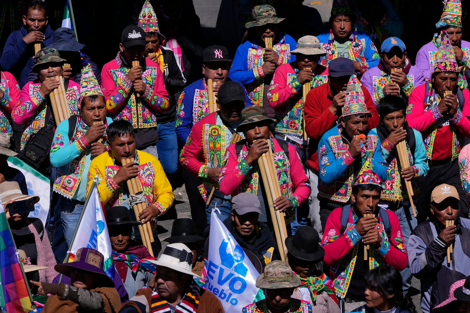 Quechua musicians play flutes in support of former President Evo Morales during a march to the Electoral Tribunal offices in El Alto, Bolivia, Friday, May 16, 2025. (AP Photo/Juan Karita)