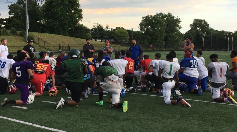 The West’s players and coaches have a post-practice meeting Tuesday at Woodward High School. RICK CASSANO/STAFF