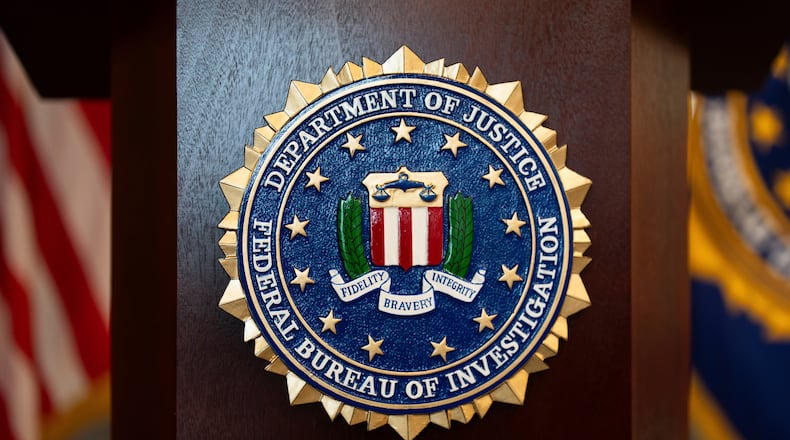 FILE - An FBI seal is displayed on a podium before a news conference at the field office in Portland, Ore., Jan. 16, 2025. (AP Photo/Jenny Kane, File)
