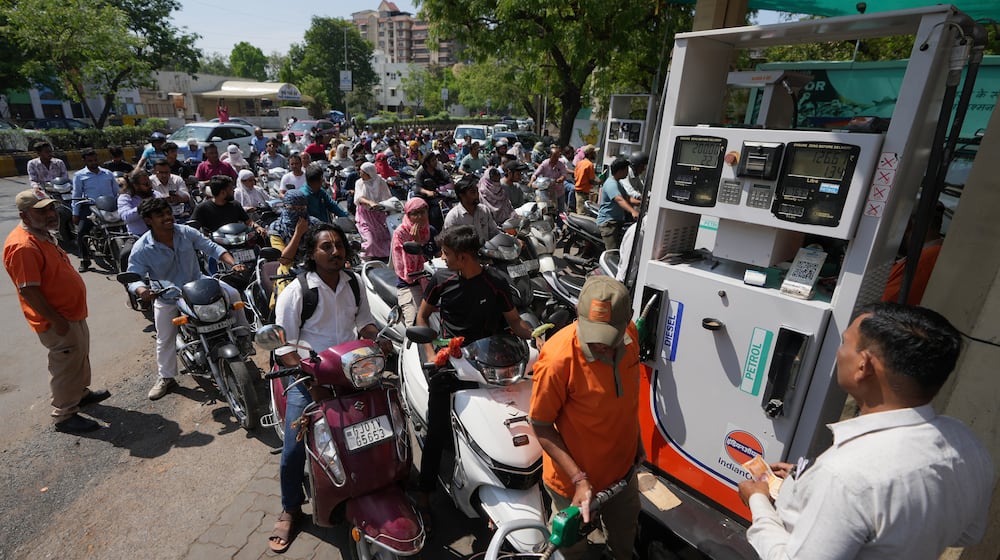 Motorists queue up to get fuel at a pump, fearing a possible fuel shortage due to the US Iran war, in Ahmedabad, India, Monday, March 23, 2026. (AP Photo/Ajit Solanki)