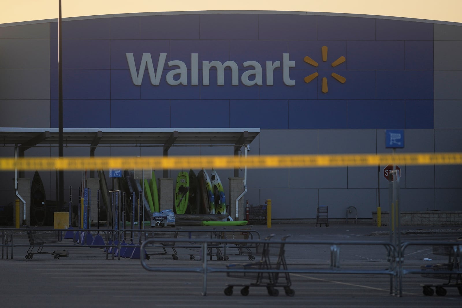 Police tape is seen outside a Walmart where multiple people were stabbed in a violent attack Saturday, July 26, 2025, in Traverse City, Mich (AP Photo/Ryan Sun)