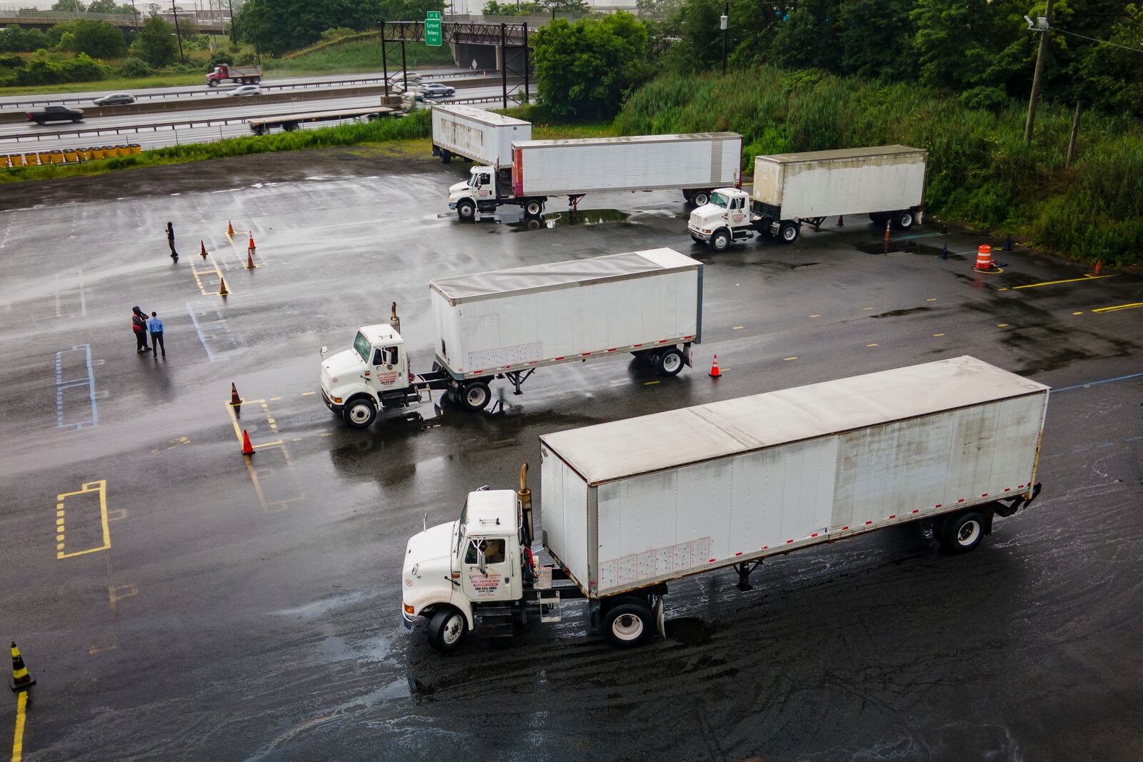 Trucking students practice reverse parking in training trucks at the Driving Academy on Thursday, Sept. 14, 2017 in Linden, N.J., where students prepare to obtain a Commercial Driver’s License (CDL) with multilingual instructors. (AP Photo/Angelina Katsanis)