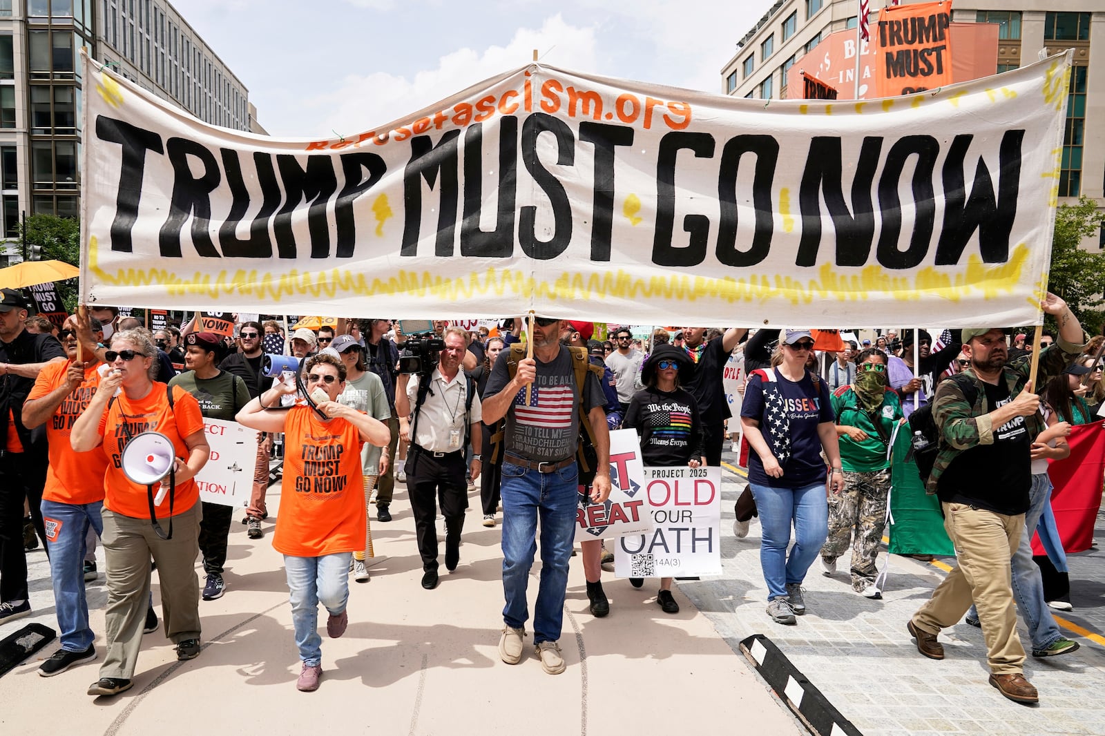 Demonstrators rally at Lafayette park during a demonstration against President Donald Trump policies in Washington, Saturday, June 14, 2025. (AP Photo/Jose Luis Magana)