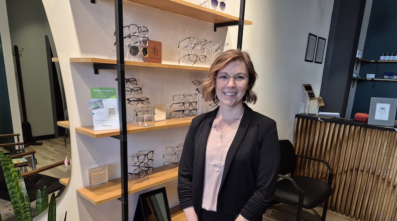 Dr. Elizabeth Eckhart, owner of Modern Eye in Dayton, offers her own vision plans as a way to keep her and customer health costs down. MICHAEL KURTZ / STAFF