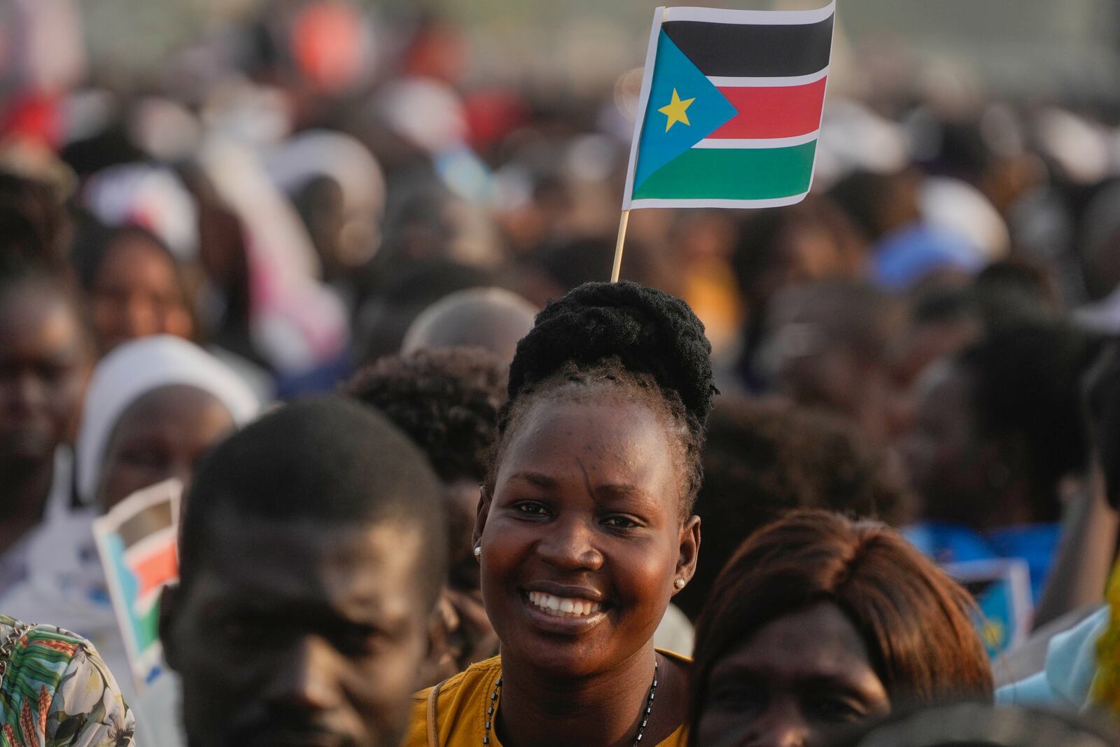 FILE - People wait for Pope Francis to arrive to give a Mass at John Garang Mausoleum in Juba, South Sudan, Feb. 5, 2023. (AP Photo/Gregorio Borgia, File)