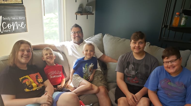 Scott Lewis is surrounded by his three step-sons and two biological sons. From left, Conner Hamrick, 20, Camden Lewis, 8, Nathan Lewis, 6, Parker Hamrick, 16, and Brady Hamrick, 12. When Lewis married in 2013, he became a step-father to three boys and he and his wife, Jeri, have had two sons. SUBMITTED PHOTO