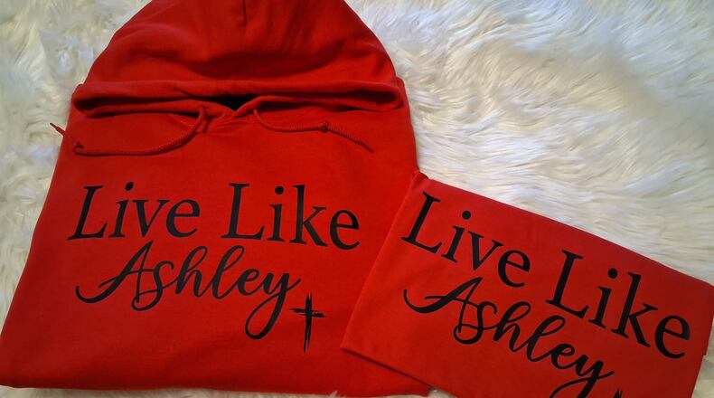 A portion of proceeds from shirts that read "Live Like Ashley" will go toward an online fundraiser to benefit the children of Ashley Flynn, a Tipp City mother, coach and educator killed Feb. 16, 2026, at her home. CONTRIBUTED