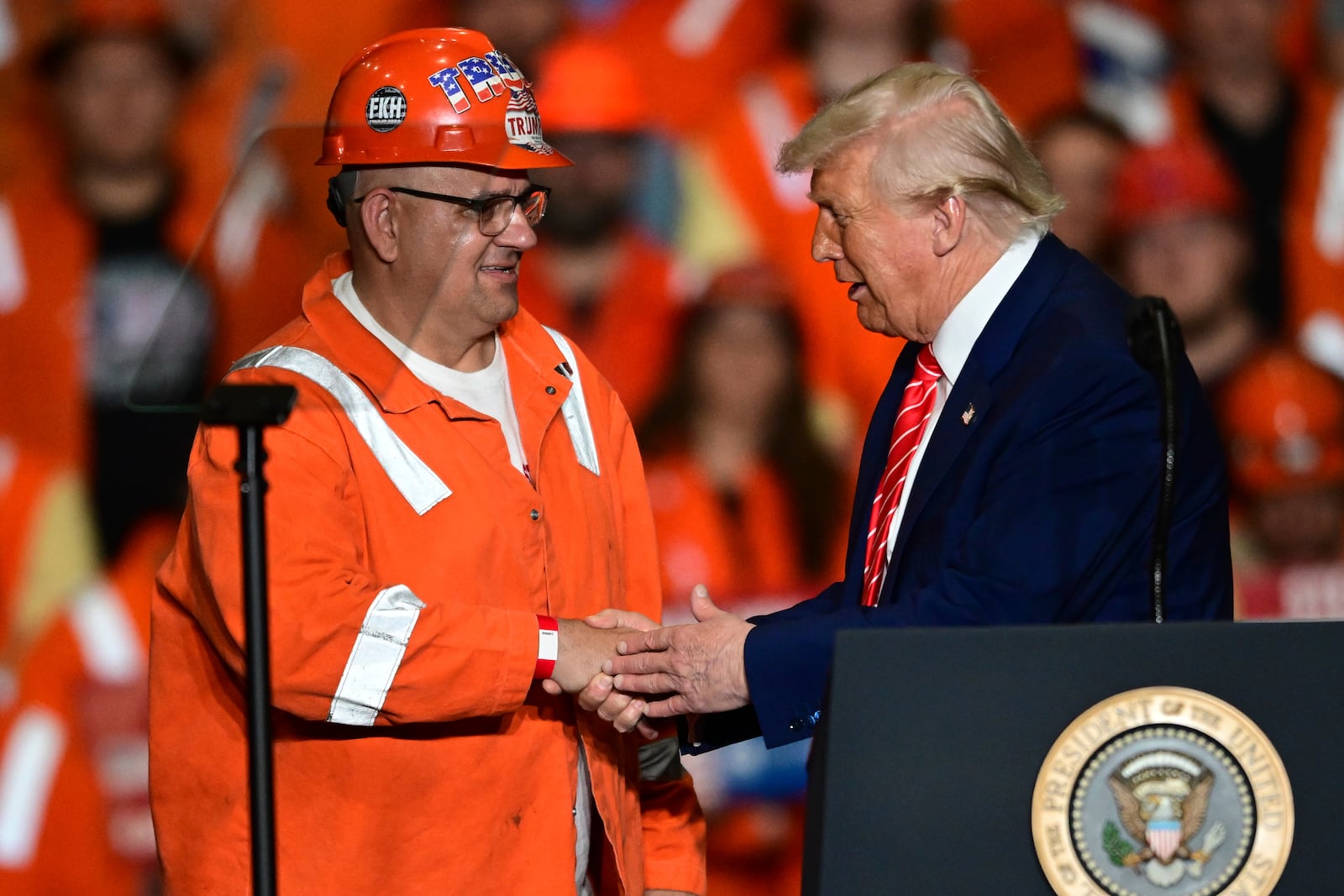 President Donald Trump greets steelworker Brian Pavlack as he speaks at the U.S. Steel Mon Valley Works-Irvin plant, Friday, May 30, 2025, in West Mifflin, Pa. (AP Photo/David Dermer)