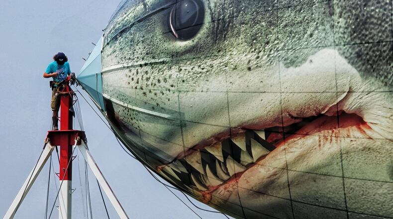 A blimp piloted by Terry Dillard featuring Discovery and Discovery+ "Shark Week" graphics landed at Middletown Municipal Airport/Hook Field for an overnight stay Tuesday, July 20, 2021 in Middletown. The 132 feet long, 67000 cubic feet airship has 200 pounds of decals on it that will be removed and replaced with something different after shark week promotion is over. NICK GRAHAM / STAFF