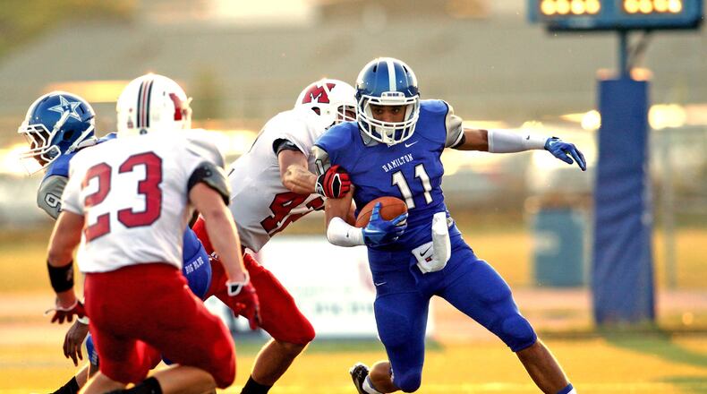 Hamilton’s Tyler Denton (11) returns a punt during a game against Milford at Virgil Schwarm Stadium in Hamilton on Aug. 30, 2013. COX MEDIA FILE PHOTO