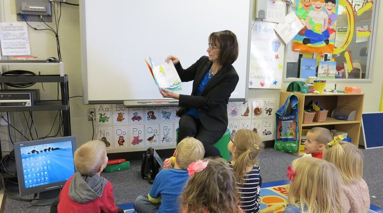 Warren County Career Center Superintendent Maggie Hess reads to preschoolers in WCCC’s state-licensed preschool, which offers hands-on learning experiences for high school students enrolled in the early childhood education program. CONTRIBUTED