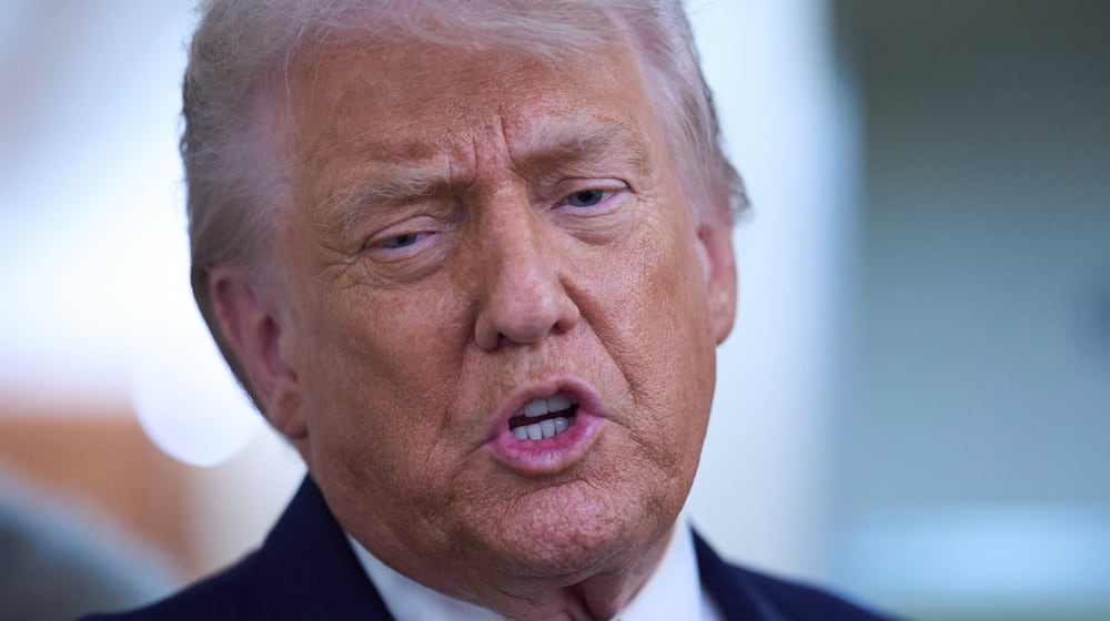President Donald Trump speaks with reporters aboard Air Force One after leaving the World Economic Forum in Davos for Washington, Thursday, Jan. 22, 2026. (AP Photo/Evan Vucci)