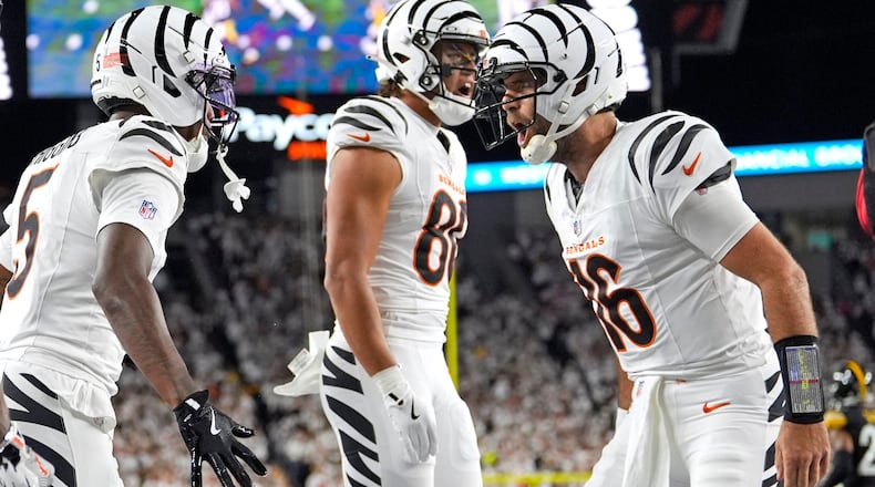 Cincinnati Bengals quarterback Joe Flacco (16) celebrates a touchdown with wide receiver Tee Higgins (5) and Andrei Iosivas, center, during the first half of an NFL football game against the Pittsburgh Steelers in Cincinnati, Thursday, Oct. 16, 2025. (AP Photo/Carolyn Kaster)