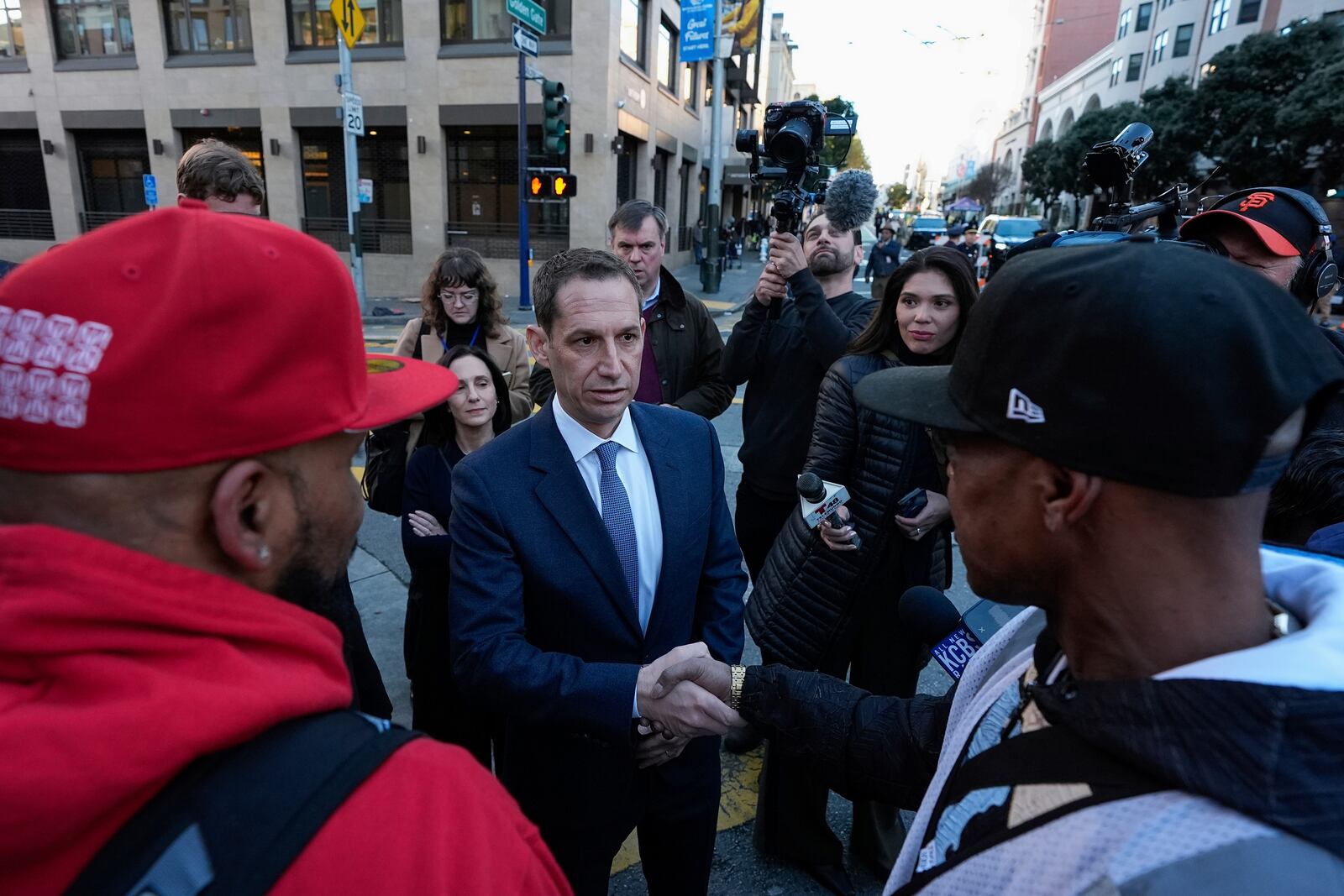 Mayor-elect Daniel Lurie, center, speaks with people in the Tenderloin neighborhood Wednesday, Jan. 8, 2025, in San Francisco. (AP Photo/Godofredo A. Vásquez)