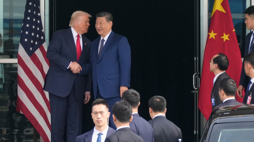 President Donald Trump left, and Chinese President Xi Jinping, shake hands before their U.S.-China summit talk at Gimhae International Airport in Busan, South Korea, Thursday, Oct. 30, 2025. (AP Photo/Mark Schiefelbein)