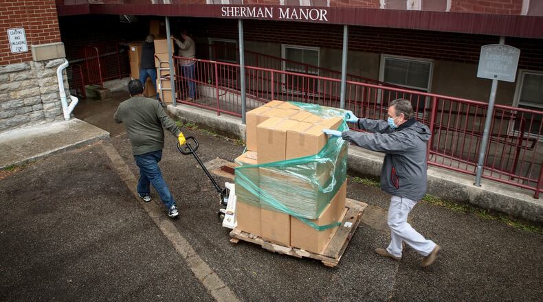 Council on Aging of Southwestern Ohio staff and volunteers deliver LaRosa s meals and personal care supplies to seniors at Sherman Manor in Hamilton Friday, April 17, 2020. COA serves approximately 26,000 individuals annually, including 5,900 who reside in Butler County. CONTRIBUTED