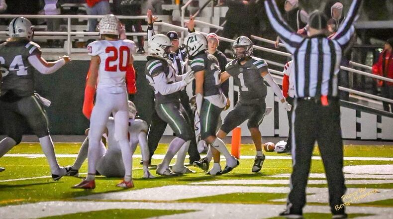 Badin's Carson Cheek (23) celebrates his game-winning touchdown with teammates on Friday night. The Rams beat Wapakoneta 14-10 to advance to the Division III regional finals. Betsey Miyahara/CONTRIBUTED