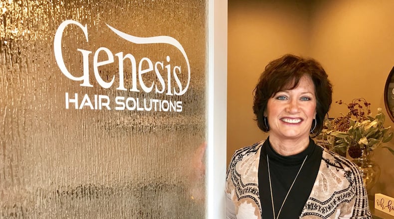 Robin Ruthemeyer, owner of Genesis Hair Solutions on Central Avenue in Middletown, stands in her salon that specializes in solutions for people with balding or thinning hair. NICK GRAHAM/STAFF
