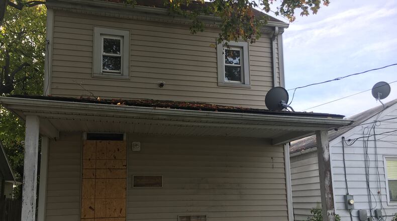 This property at 1024 Azel Ave. in Hamilton is the subject of a tug-of-war between the city, which wants to tear it down, and its new owner, Odell Barnes Jr., who wants to rehab it and sell it to a working, lower-income family. MIKE RUTLEDGE/STAFF