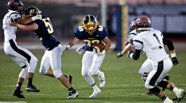 Monroe’s Connor Curtis carries the ball during a game against visiting Franklin on Oct. 16, 2015. NICK GRAHAM/STAFF