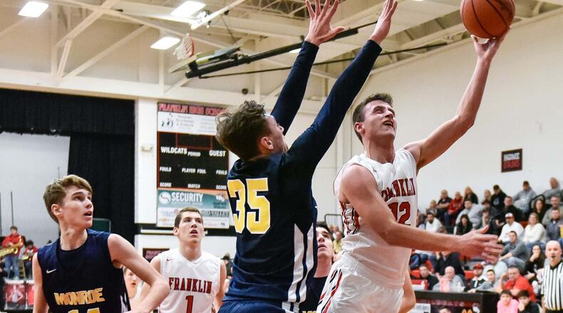Franklin’s Braden Hall puts up a shot while being defended by Monroe’s Caimanne Turner during Friday night’s game at Darrell Hedric Gym in Franklin. NICK GRAHAM/STAFF
