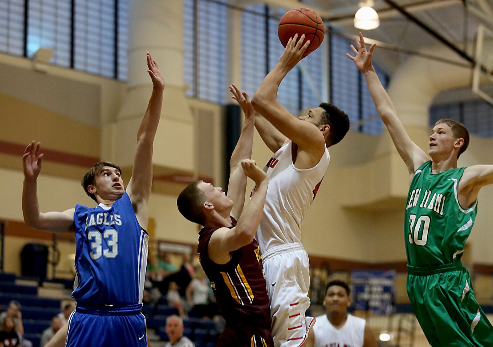 Fairfield’s Ben Phillips goes up for a shot between Middletown Christian’s Jarod Hamlin (33), Ross’ Joey Wright and New Miami’s Joe Mack (30) during the inaugural All-Butler County All-Star boys basketball game at the Hamilton Athletic Center on Saturday. CONTRIBUTED PHOTO BY E.L. HUBBARD
