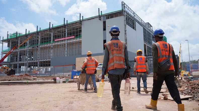 FILE -Construction workers walk to a data center building under construction in Sedenak Tech Park in Johor state of Malaysia, Sept. 27, 2024. (AP Photo/Vincent Thian, File)