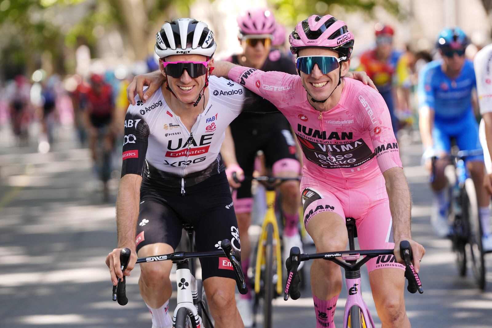 Britain's Simon Yates, in the pink jersey, shares a light moment with his brother Adam Yates, during the last stage of the Giro d'Italia cycling race, in Rome, Sunday, June 1, 2025. (Fabio Ferrari/LaPresse via AP)