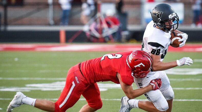 Lakota East’s Evan Yablonsky tries to get away from Fairfield’s Kyle Schimpf during a Sept. 15 game at Fairfield Stadium. The host Indians won 48-14. NICK GRAHAM/STAFF