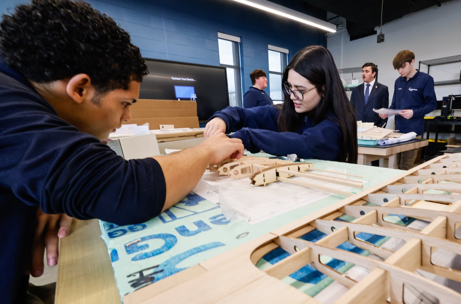 Nelson Fernandez, left, and Lilah Ball work on building a model airplane wing after the ribbon cutting for Butler Tech's new Aviation Center Monday, March 16, 2026 at Middletown Regional Airport. NICK GRAHAM/STAFF