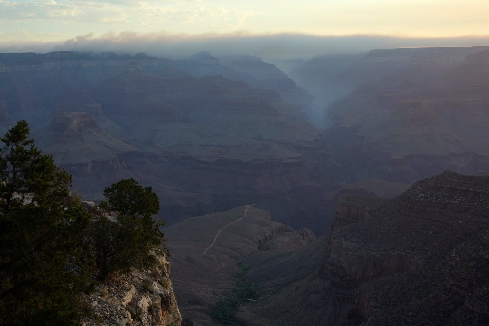 Smoke from the Dragon Bravo Fire moves over the Grand Canyon from the North Rim Tuesday, July 15, 2025, in Grand Canyon National Park, Ariz. (AP Photo/Ross D. Franklin)