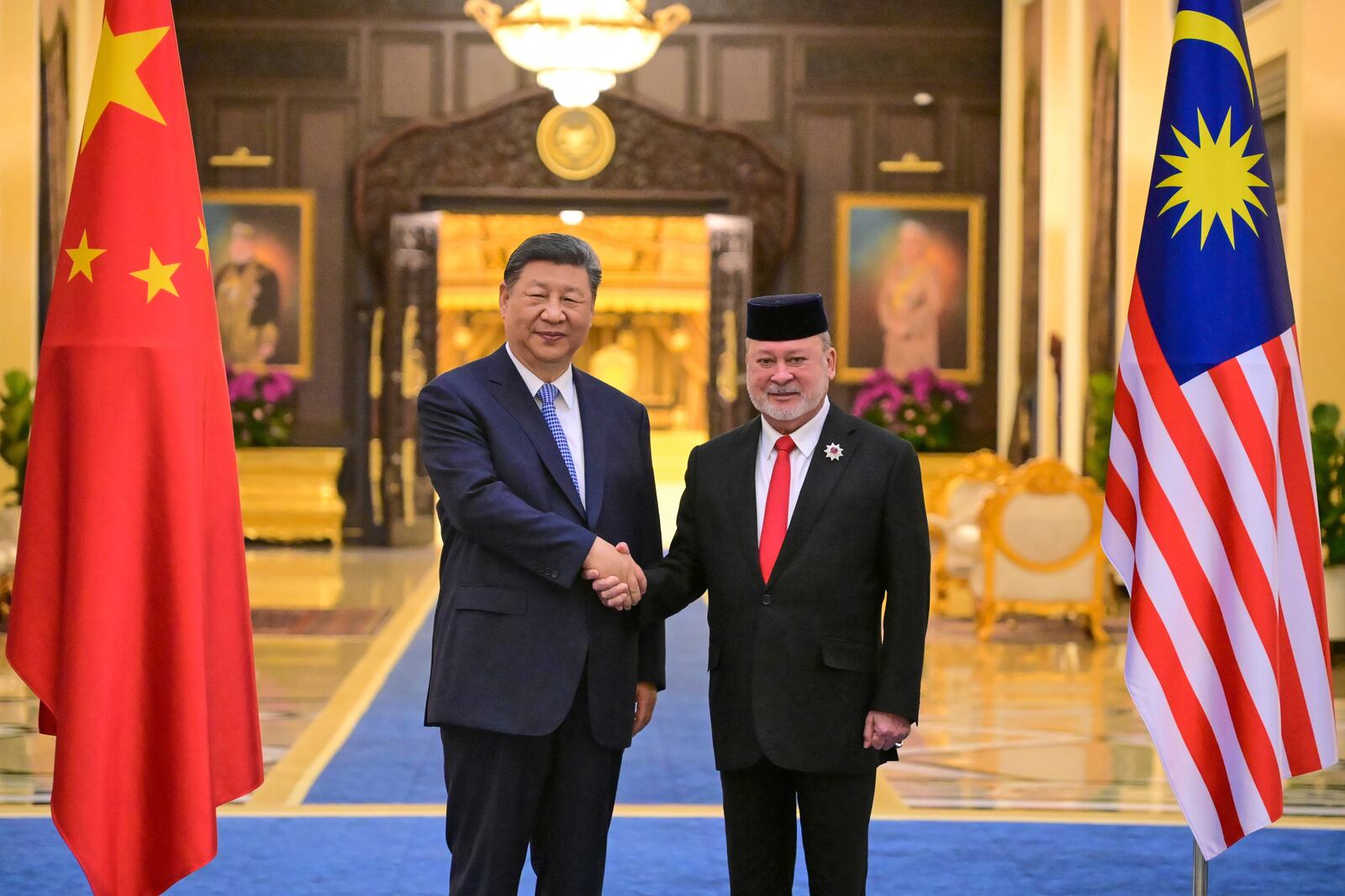 This photo taken and released by Malaysia's Department of Information on April 15, 2025 shows Malaysia's King Sultan Ibrahim, right, shaking hands with China's President Xi Jinping after the welcoming ceremony at the National Palace in Kuala Lumpur. (Azali Ariffin/ Malaysia's Department of Information via AP)
